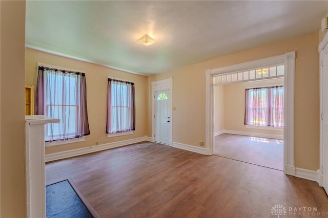 entryway with wood finished floors and baseboards