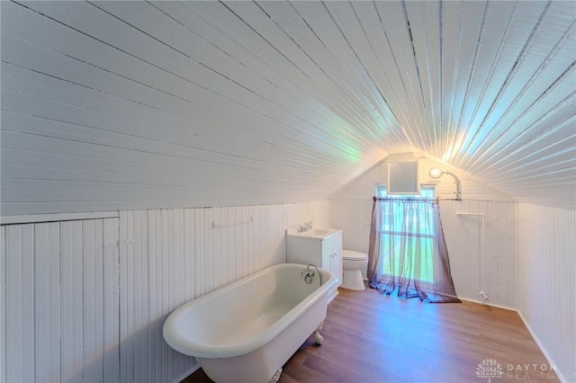 full bathroom featuring wood walls, toilet, a freestanding bath, and wooden ceiling