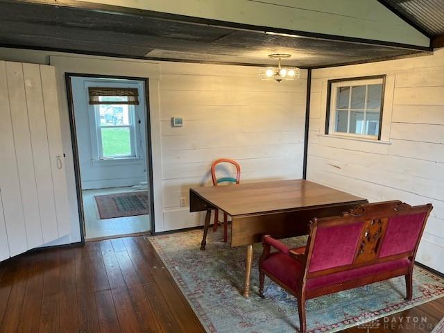 3668 Concord Fairhaven Rd, Eaton, OH 45320 - dining area featuring dark wood finished floors, wood walls, and a chandelier