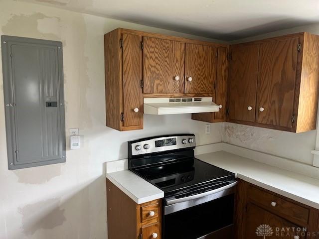3668 Concord Fairhaven Rd, Eaton, OH 45320 - kitchen featuring under cabinet range hood, stainless steel electric stove, electric panel, and light countertops