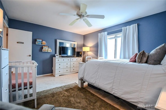bedroom featuring baseboards, a ceiling fan, and light colored carpet