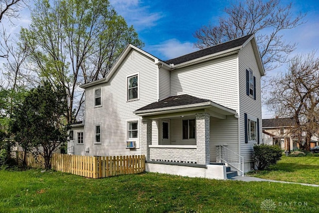 exterior space featuring cooling unit, a lawn, and fence