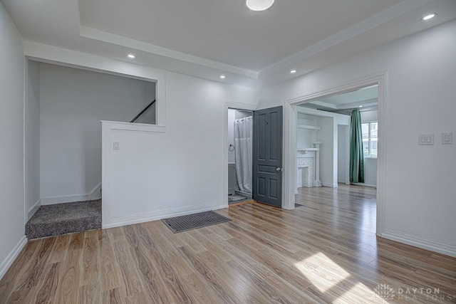 spare room featuring recessed lighting, wood finished floors, and baseboards