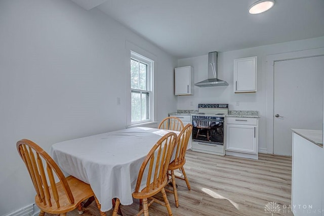 dining space with light wood-type flooring