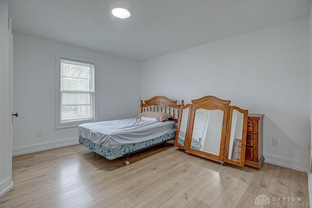 bedroom with baseboards and light wood-style floors