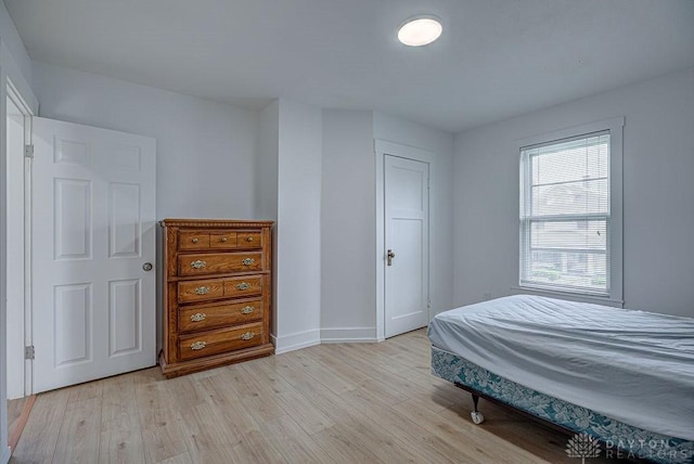 bedroom featuring light wood-style flooring and baseboards
