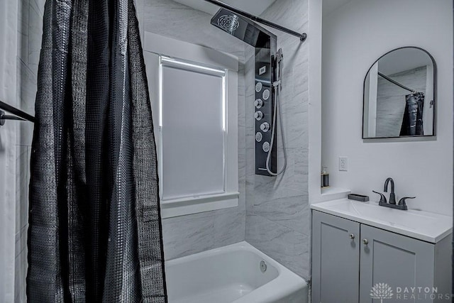 bathroom featuring shower / bath combo with shower curtain and vanity