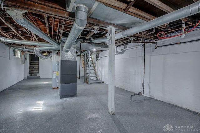 unfinished basement featuring heating unit, electric water heater, and stairs