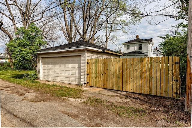 detached garage featuring fence