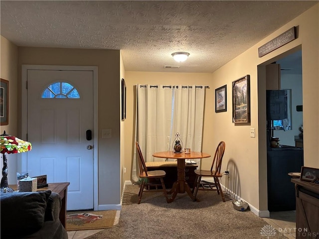 dining area featuring visible vents, baseboards, and light carpet