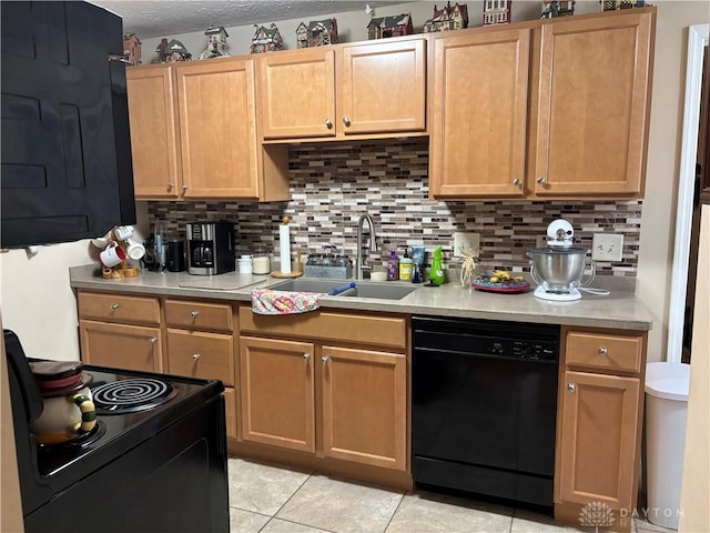kitchen with black appliances, a sink, light countertops, and tasteful backsplash