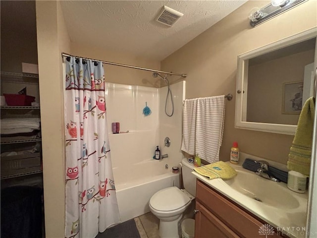 bathroom featuring a textured ceiling, visible vents, toilet, tile patterned floors, and vanity