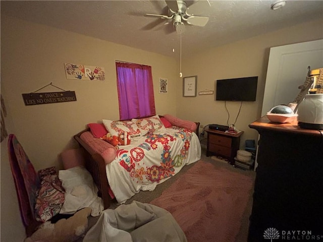 bedroom with a ceiling fan and carpet floors