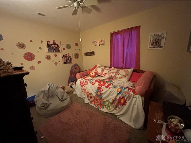 bedroom with carpet, ceiling fan, and visible vents