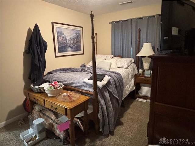bedroom with baseboards, visible vents, a textured ceiling, and carpet flooring