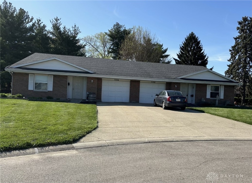 5106-5108 Foxmoor Cir, Centerville, OH 45429 - ranch-style home featuring an attached garage, brick siding, driveway, and a front yard