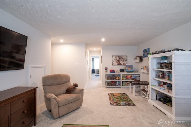 living room with recessed lighting, a textured ceiling, and carpet