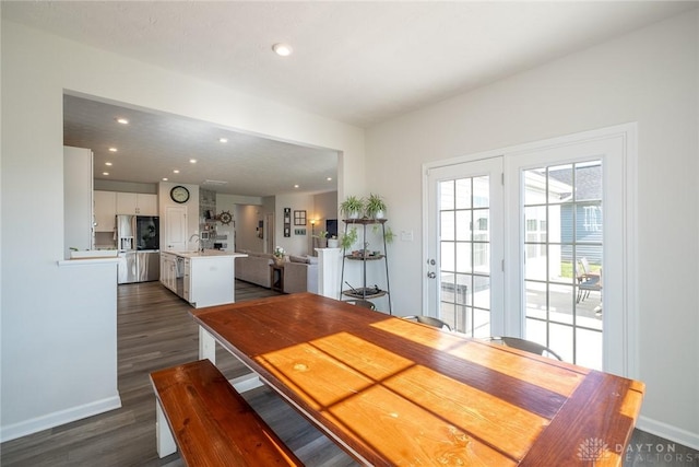 dining area featuring baseboards, recessed lighting, and dark wood-type flooring