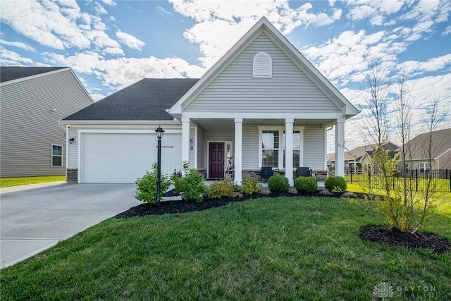 view of front of home featuring covered porch, fence, driveway, a front yard, and an attached garage