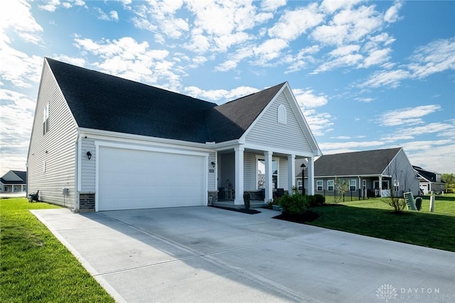 view of front facade featuring concrete driveway, roof with shingles, covered porch, a front yard, and a garage