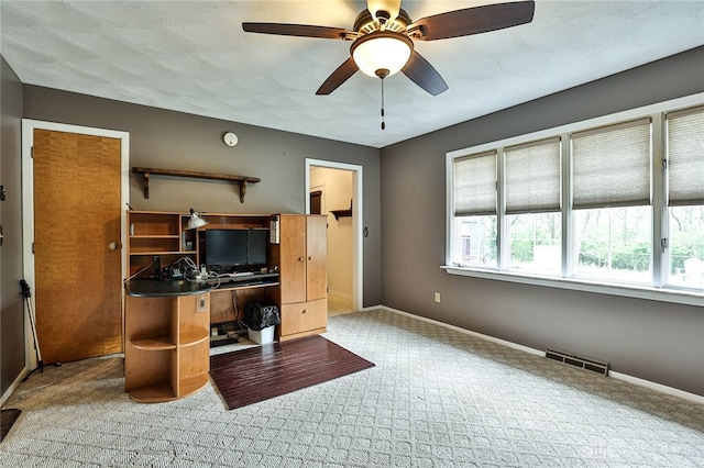 carpeted office space with visible vents, baseboards, and a healthy amount of sunlight
