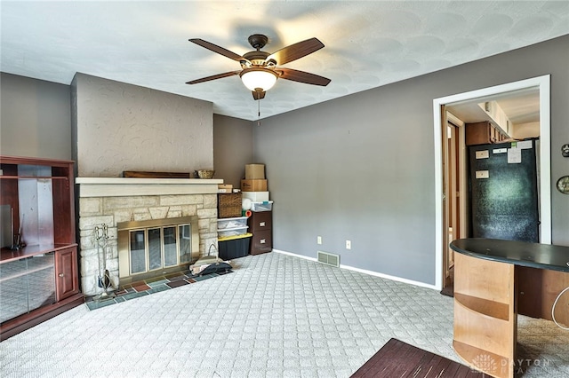 10699 Hamilton Ave, Cincinnati, OH 45231 - unfurnished living room with carpet floors, baseboards, a ceiling fan, and a fireplace