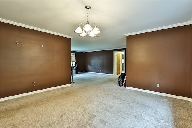 empty room with a chandelier, ornamental molding, and carpet
