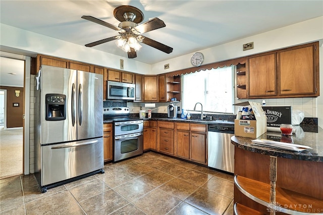10699 Hamilton Ave, Cincinnati, OH 45231 - kitchen featuring stainless steel appliances, open shelves, a sink, decorative backsplash, and brown cabinets