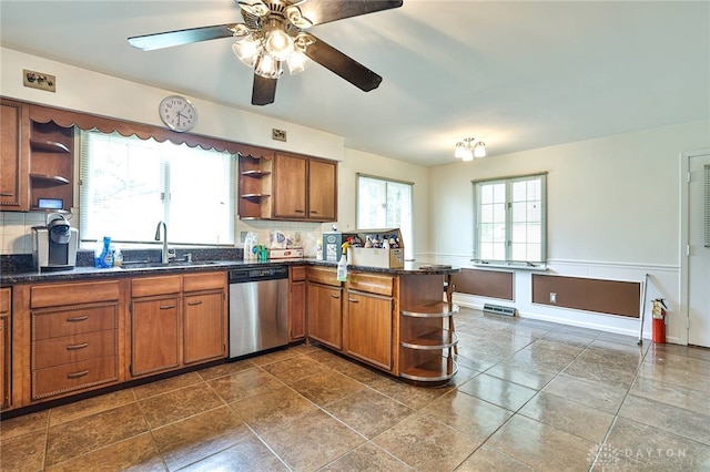 kitchen with stainless steel dishwasher, open shelves, brown cabinetry, and a sink