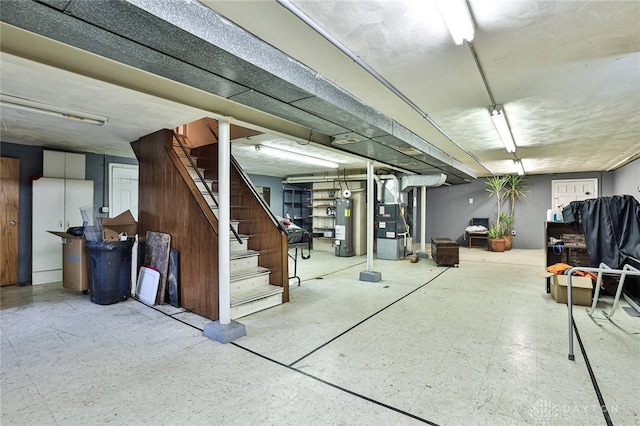 10699 Hamilton Ave, Cincinnati, OH 45231 - finished basement featuring heating unit, gas water heater, tile patterned floors, and stairway