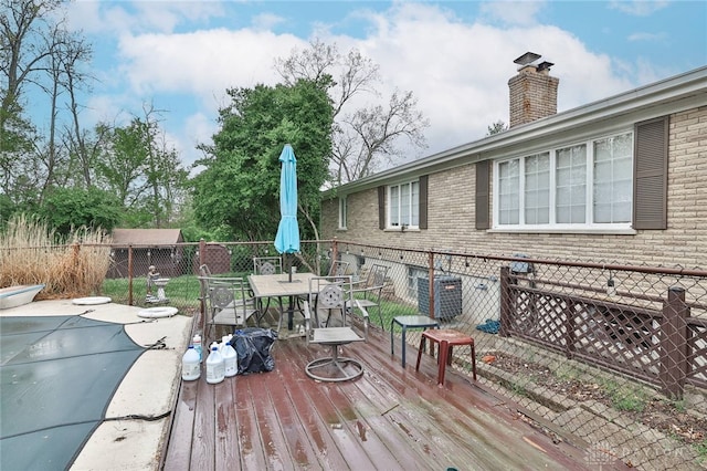 deck with outdoor dining area and a fenced backyard