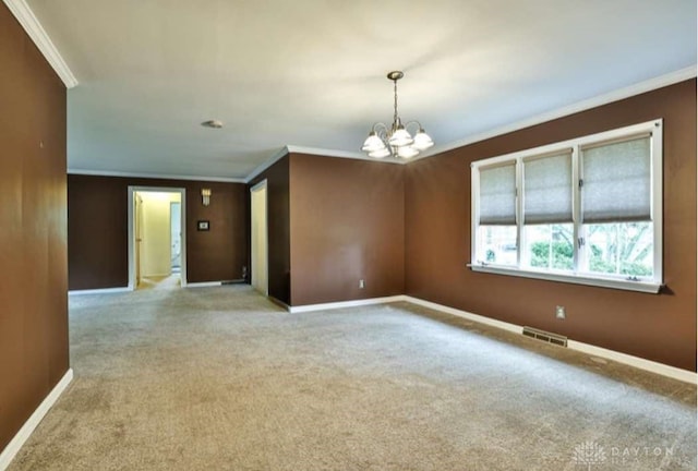 10699 Hamilton Ave, Cincinnati, OH 45231 - carpeted empty room with ornamental molding, a chandelier, and baseboards