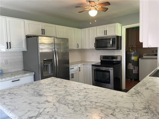 928 Shady Ln, Beavercreek, OH 45434 - kitchen with appliances with stainless steel finishes, water heater, washer / clothes dryer, a ceiling fan, and white cabinetry