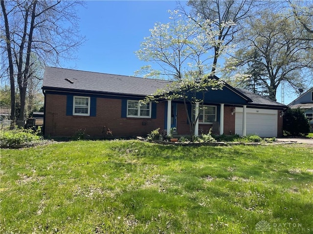 928 Shady Ln, Beavercreek, OH 45434 - view of front of house with brick siding, a garage, a front yard, and driveway