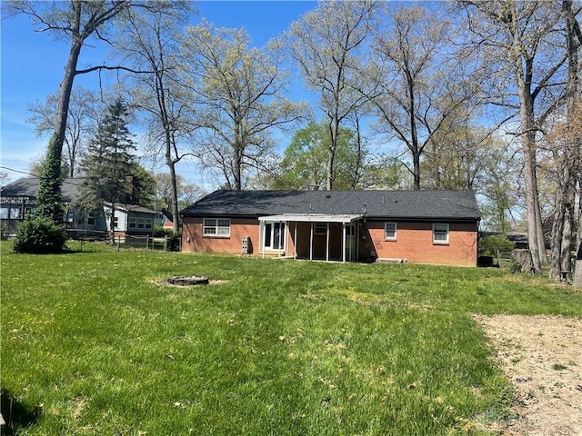 928 Shady Ln, Beavercreek, OH 45434 - rear view of house featuring a yard, brick siding, and an outdoor fire pit