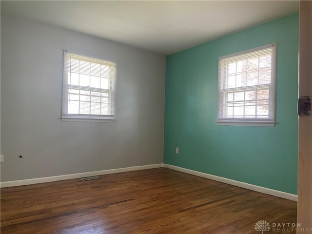 928 Shady Ln, Beavercreek, OH 45434 - empty room with healthy amount of natural light, wood finished floors, and baseboards