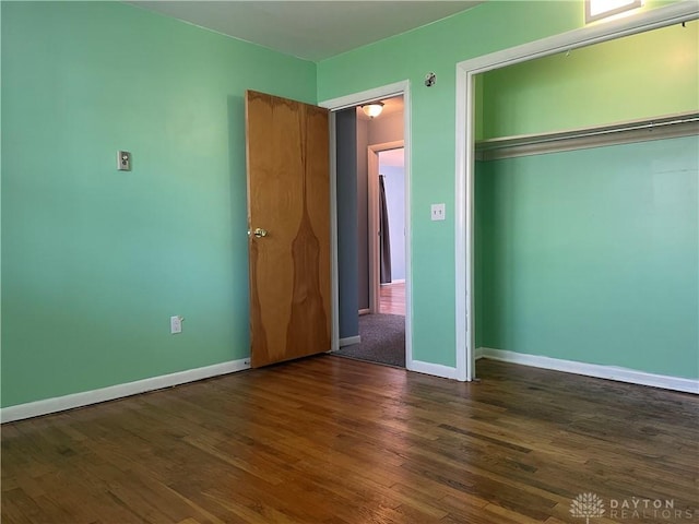 928 Shady Ln, Beavercreek, OH 45434 - unfurnished bedroom featuring dark wood finished floors, a closet, and baseboards