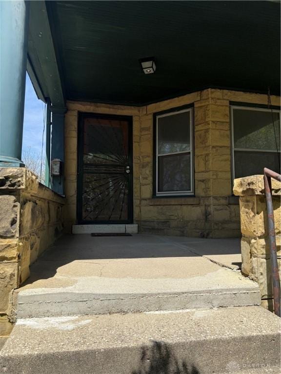 doorway to property featuring stone siding