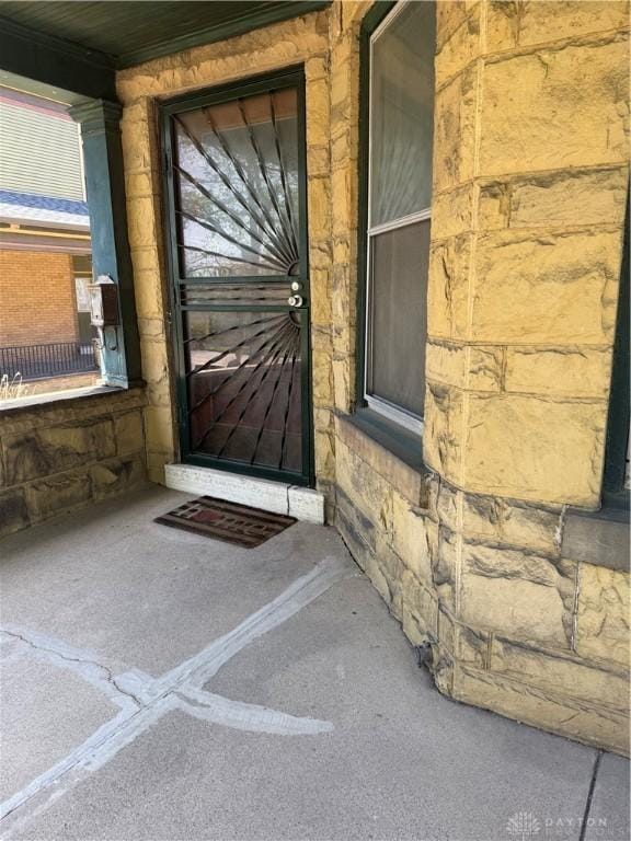 property entrance featuring stone siding