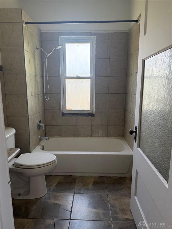 bathroom featuring toilet and shower / washtub combination