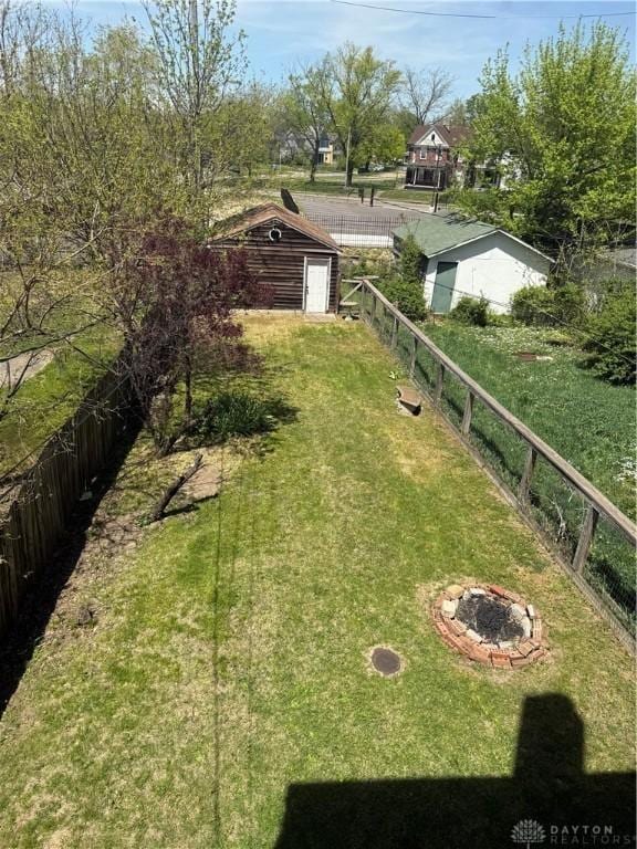 view of yard featuring fence and an outdoor structure