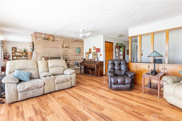 living room with ceiling fan and wood finished floors