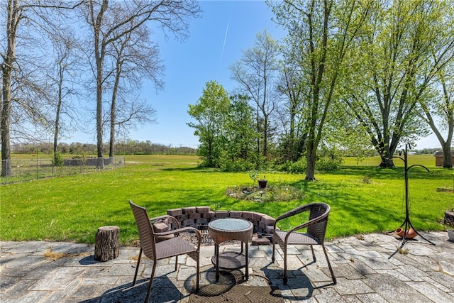 view of patio featuring fence and a rural view