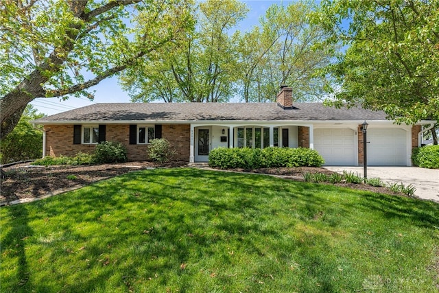 single story home with driveway, a chimney, a front yard, brick siding, and an attached garage
