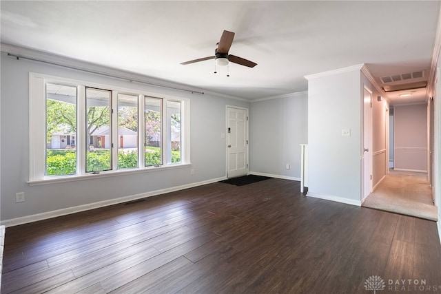 unfurnished living room featuring crown molding, baseboards, dark wood finished floors, and visible vents