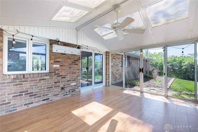 unfurnished sunroom with a ceiling fan and a wealth of natural light