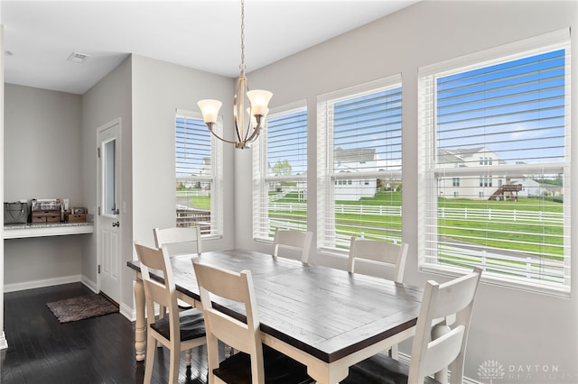 1621 Stonebury Ct, Xenia, OH 45385 - dining room with a chandelier, dark wood-style flooring, and baseboards