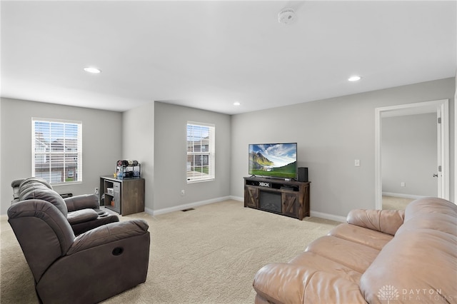 1621 Stonebury Ct, Xenia, OH 45385 - living area featuring light carpet, baseboards, recessed lighting, and plenty of natural light
