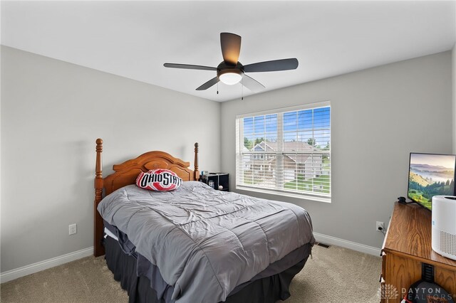 1621 Stonebury Ct, Xenia, OH 45385 - bedroom featuring light carpet, baseboards, and ceiling fan