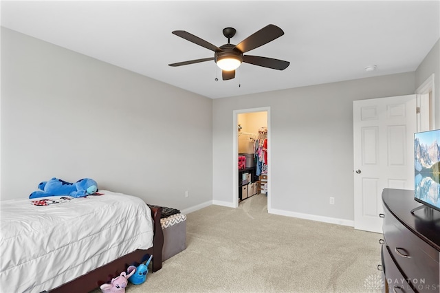 1621 Stonebury Ct, Xenia, OH 45385 - bedroom featuring light carpet, baseboards, a ceiling fan, and a spacious closet